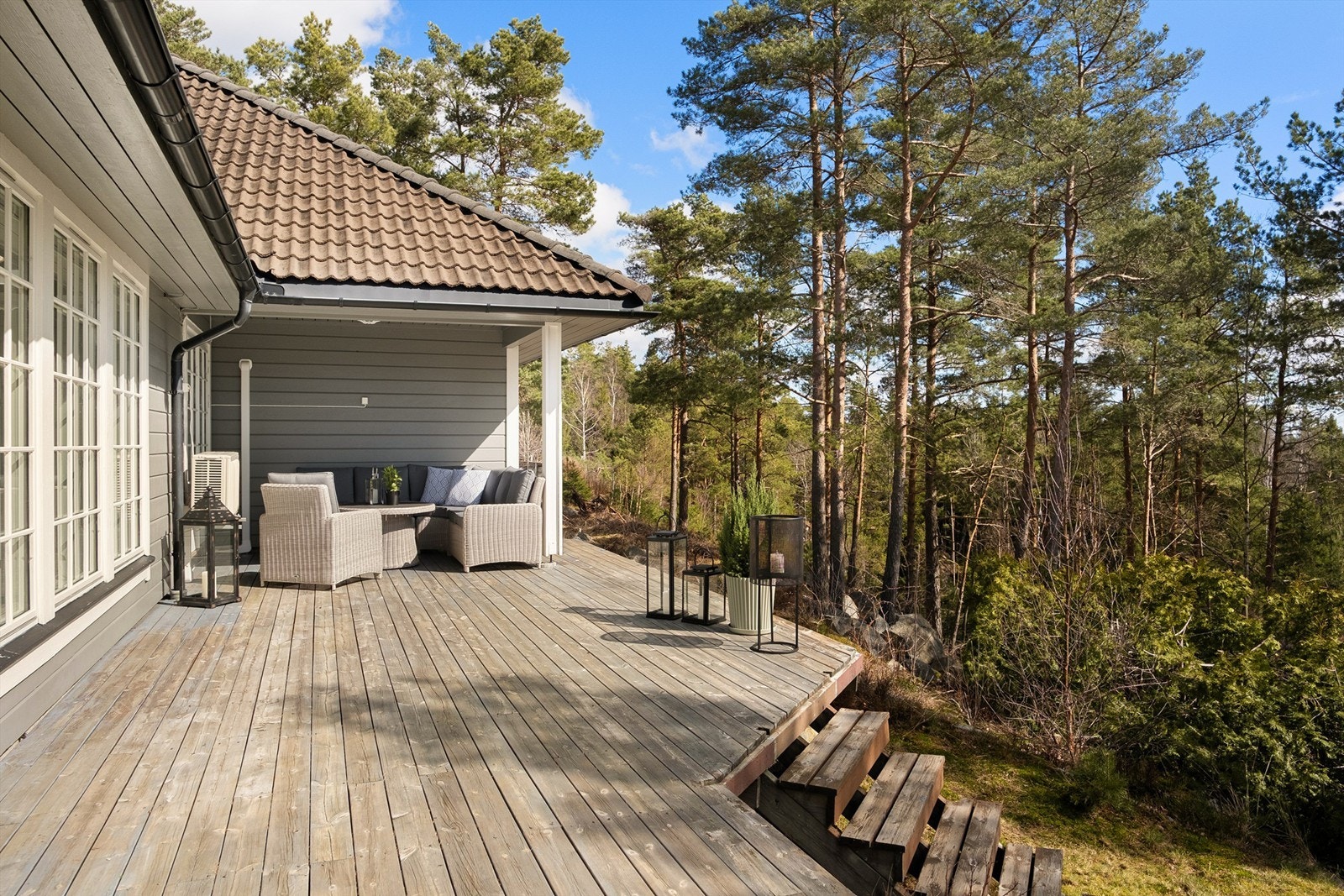 I kroken under taket innerst på terrassen er det lun og hyggelig å sitte ute også på lyse sommerkvelder - helt usjenert. Galleribilde
