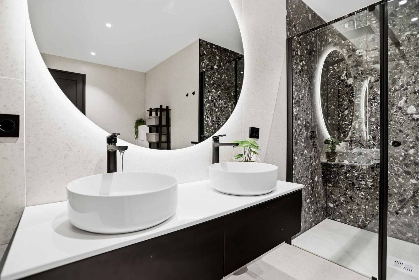 Varme er lagt i gulvet, og badet har downlights og vegghengt toalett. Et romslig dusjhjørne er utstyrt med regnfallsdusj og svingbar glassdør. Galleribilde
