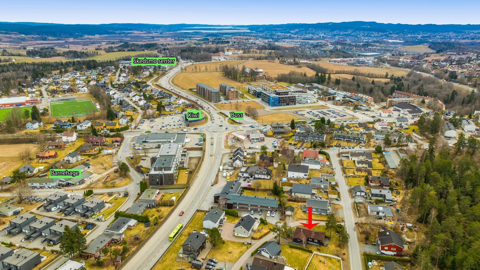 Dronebilde 1 som viser nærområde. Eiendommen ligger skjermet, men sentralt til på Skedsmokorset. Det er kort vei til buss, en Kiwi butikk, Skedsmosenteret med mer. Galleribilde