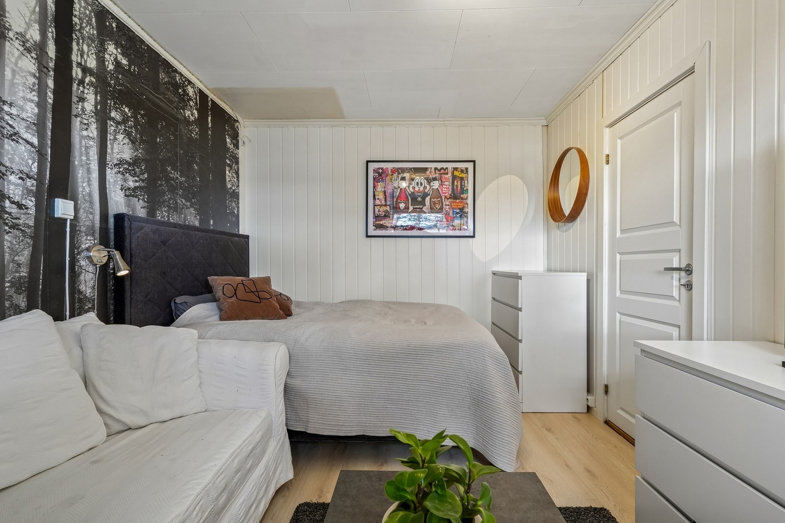 Det er laminat på gulvet og på veggene er det tapet og malt panel. Galleribilde