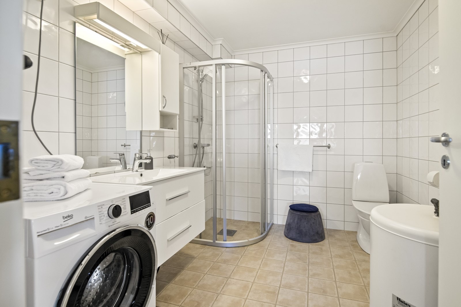 I 2021 ble badet oppgradert med nytt servantskap og nye skyvedører i dusjhjørnet. Skapseksjonen har hvite skuffer, plassert under et hvitt veggskap og et speil med belysning. Galleribilde