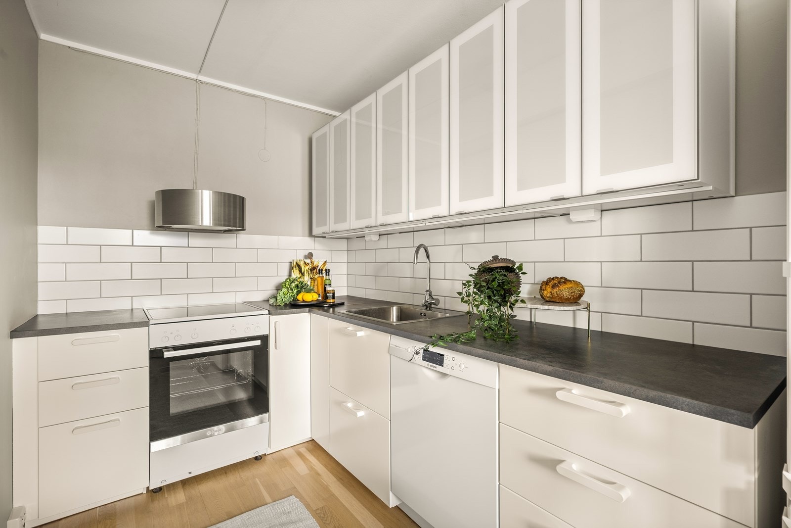 Kjøkkeninnredning fra IKEA med glatte fronter og laminat benkeplate, utstyrt med nedfelt vaskekum. Galleribilde