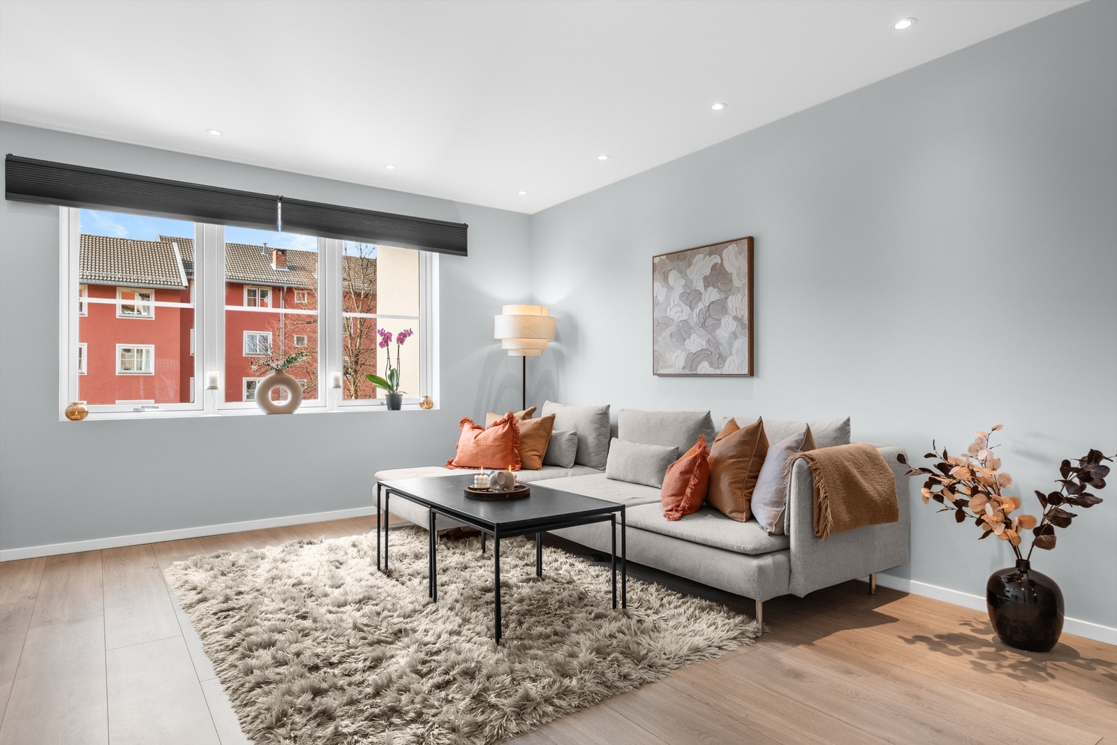 Meget flott stue med lyst 1-stavs laminatgulv, glatte veggflater i moderne fargevalg og downlights i himling Galleribilde