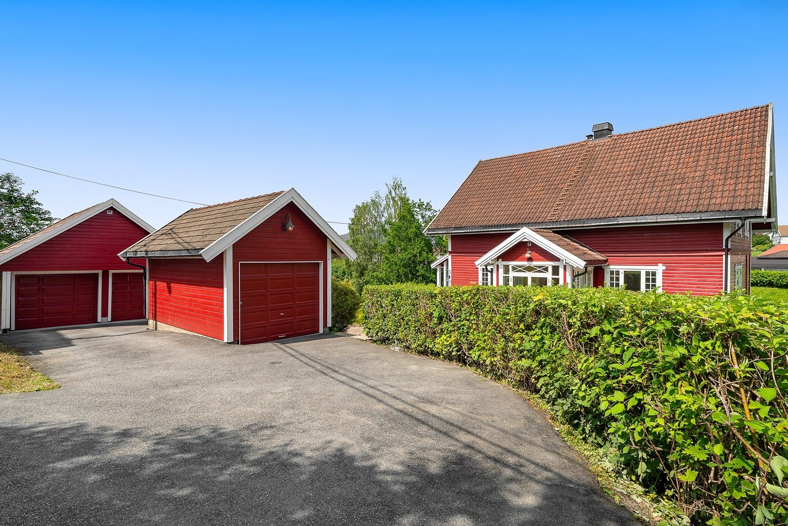 I tillegg til to frittstående garasjer, er det god plass til biler på gårdsplassen. Det er montert elbillader i dobbeltgarasje. Den ene garasjen er på ca. 14 kvm, mens den andre har et areal på rundt 30 kvm. Sistnevnte ble oppført i 2010. Galleribilde
