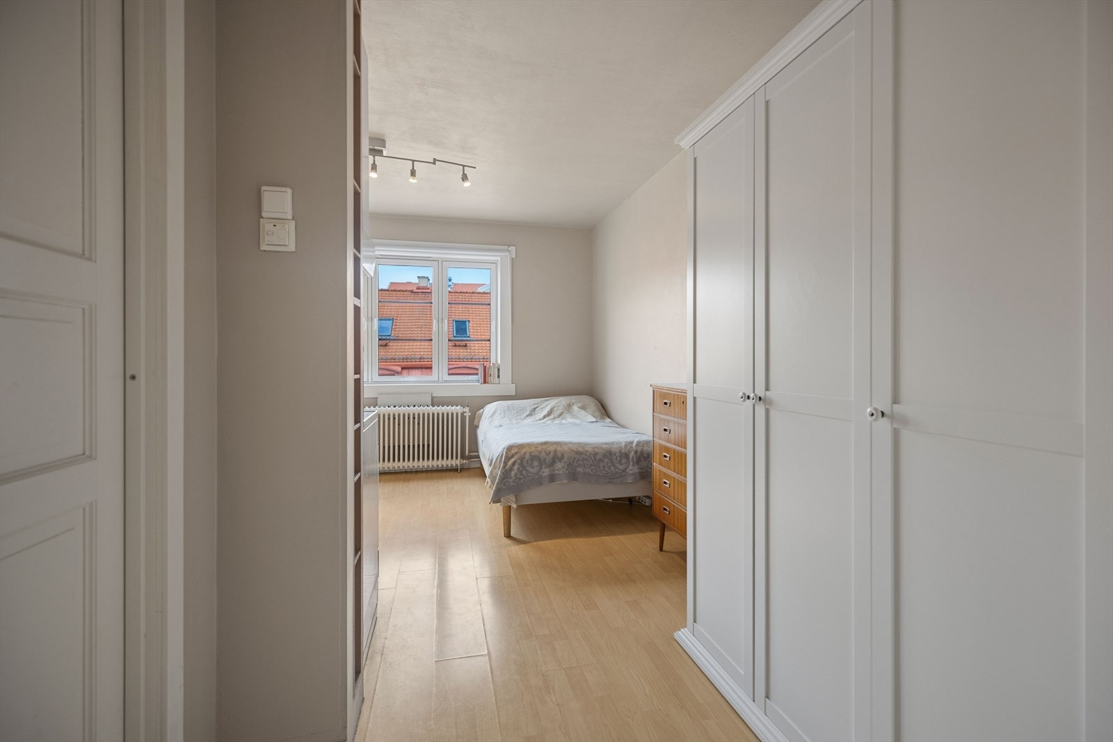 Entré med store hvite garderobeskap langs veggen og sikt inn mot resten av leiligheten. Entrédøren er brann og lydklassifisert. Galleribilde