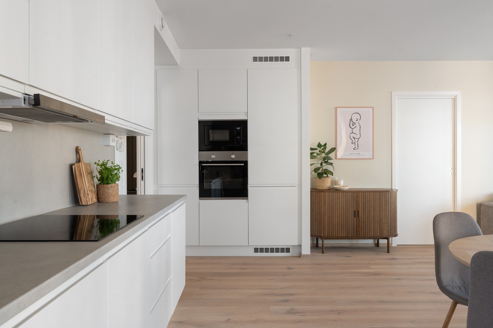 Lekkert kjøkken med takhøye skap og stekovn i arbeidshøyde.