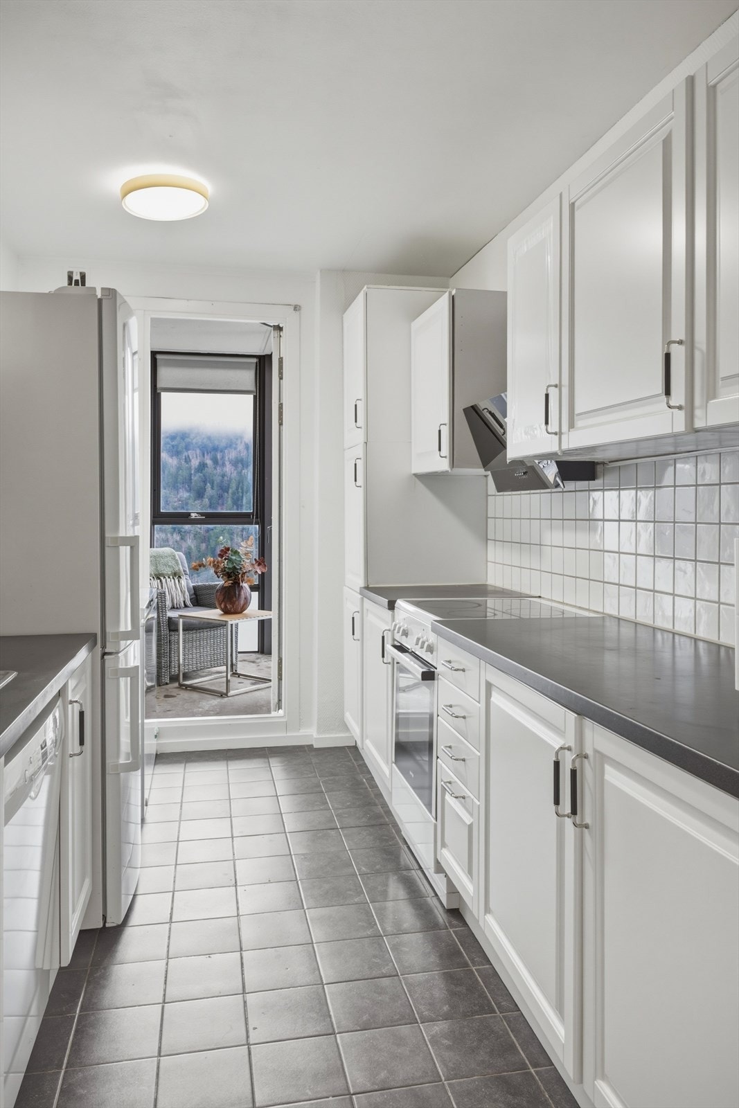 Videre er kjøkkenet utstyrt med hvitevarer som komfyr, fryseskap, kjøl/fryseskap og oppvaskmaskin Galleribilde