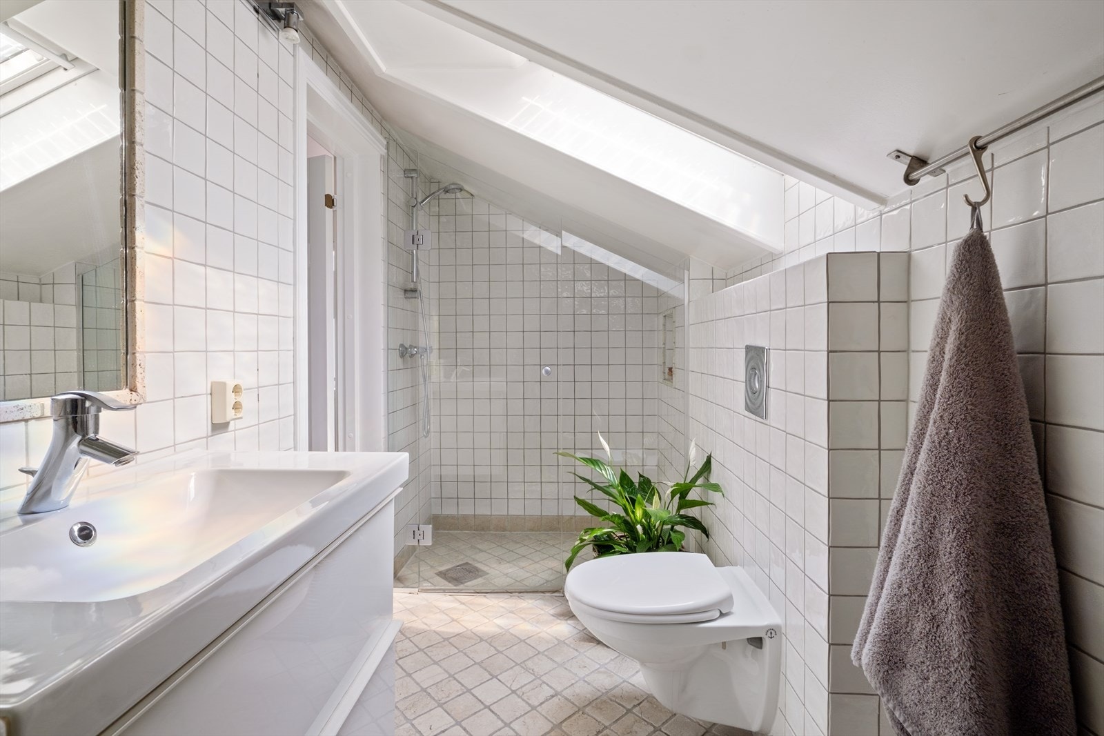 Badet er ellers innredet med servant, veggmontert WC og dusj med dører i herdet glass. Galleribilde