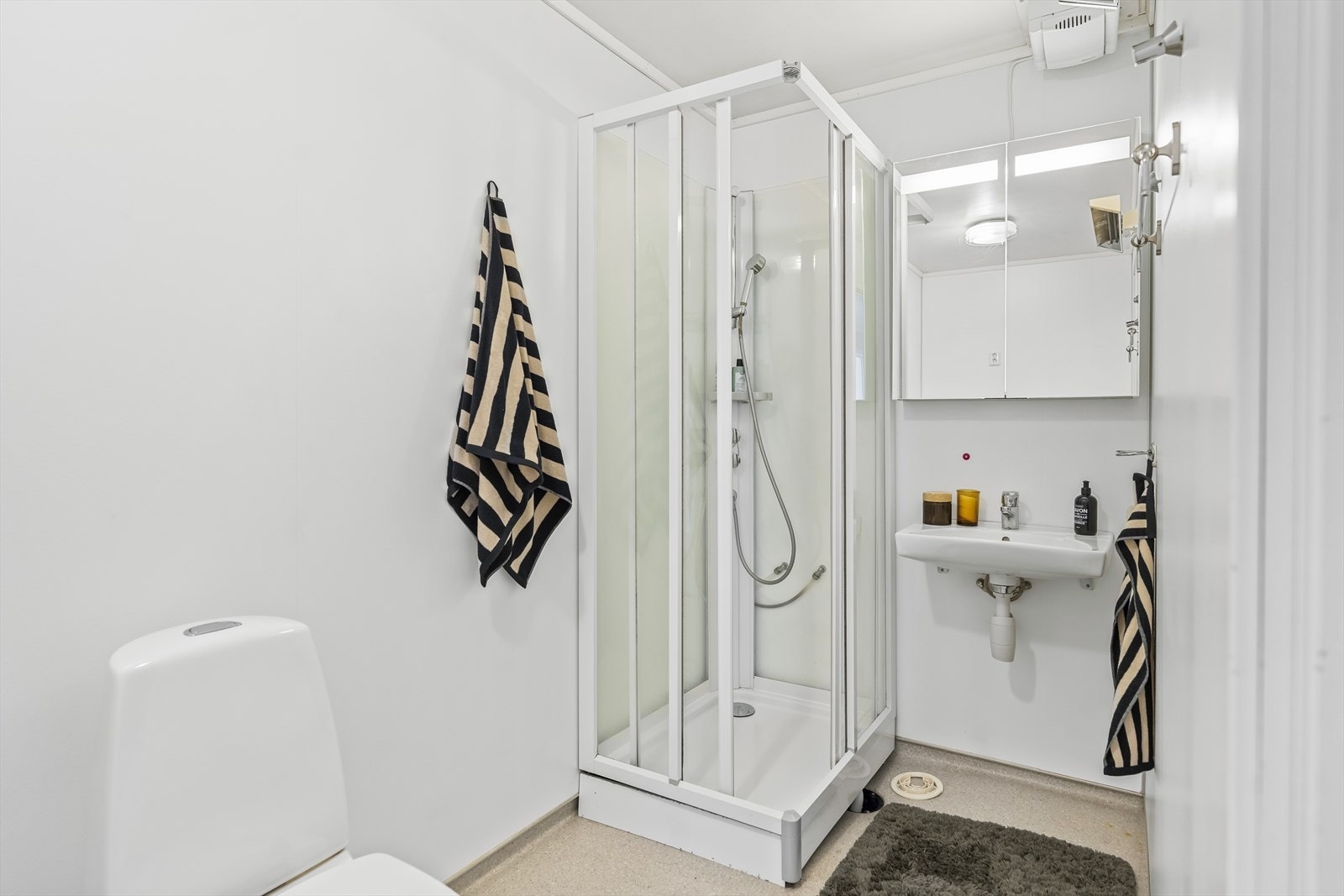 Badet består av wc, dusjkabinett, speilskap og servant Galleribilde