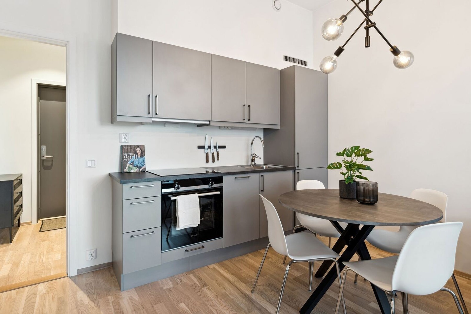 Kjøkkenet har en moderne og stilren innredning med glatte fronter og laminert benkeplate. Det er integrerte hvitevarer, herunder stekeovn, platetopp, oppvaskmaskin samt kjøleskap med fryser. Galleribilde