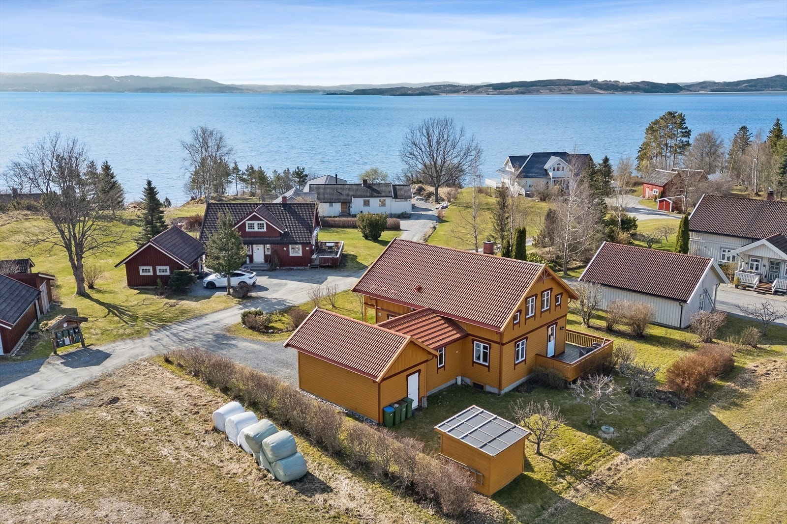 Eiendommen er plassert på et flatt parti i terrenget, omkranset av hage. Galleribilde