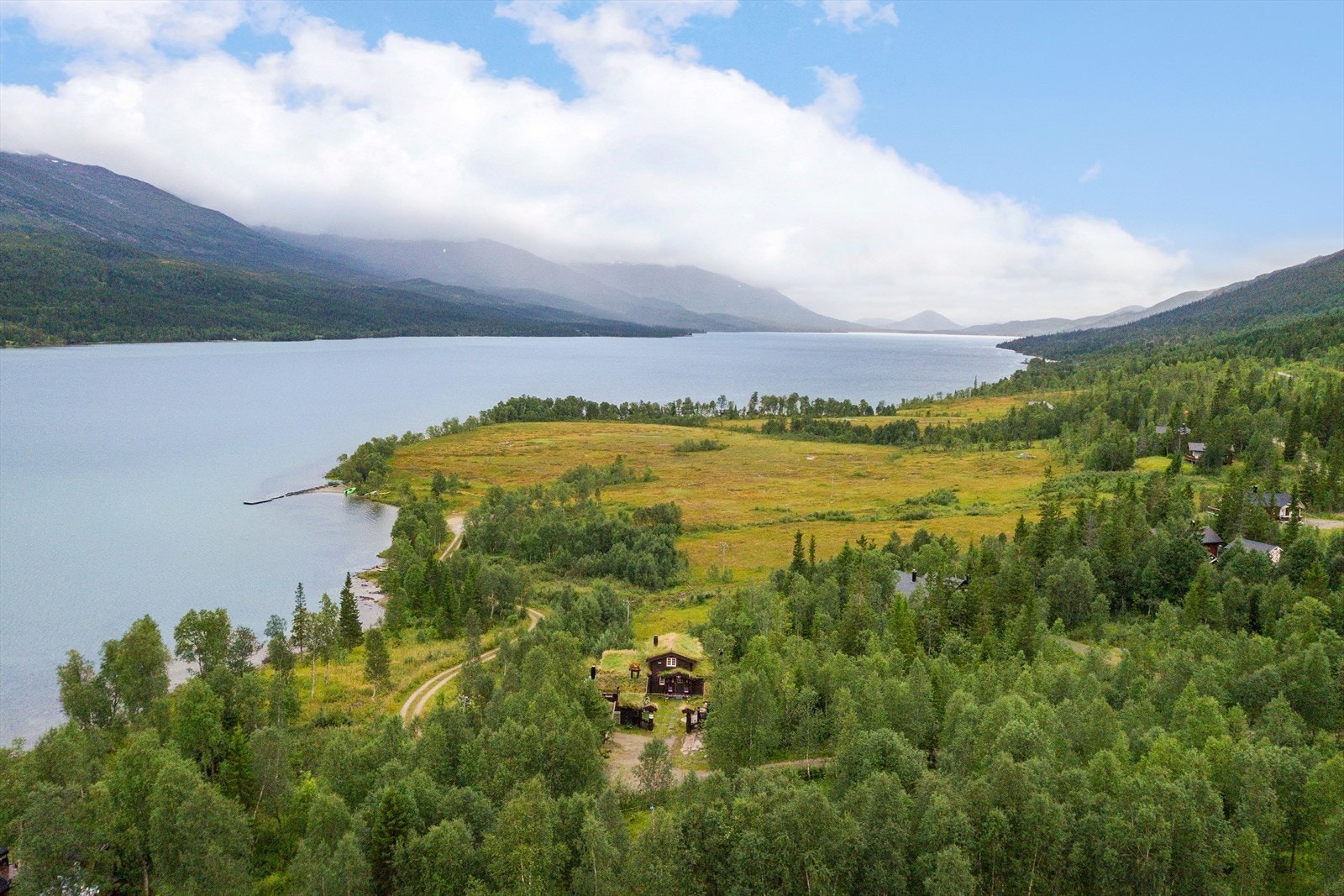 Beliggenhet i et naturskjønt område med flotte fjellområder, fiskevann og turområder. Hytta er perfekt tilpasset tomta og landskapet, med tradisjonelt torvtak og mørk kledning. Omkranset av vakker natur i et område yndet for bl.a. jakt og fiske. Galleribilde