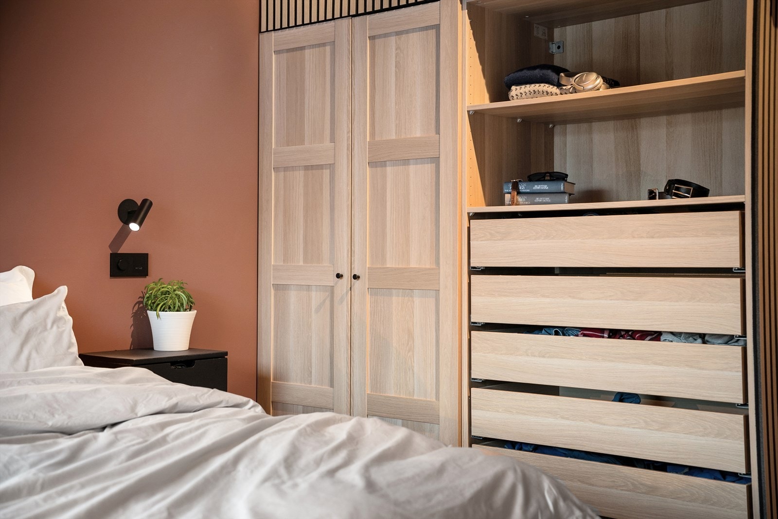 Innholdsrik garderobe med veldig godt hyllesystem. Smart lagt opp med nattbord - belysning og stikkontakter for lading av telefon, lese bok m.m. Galleribilde