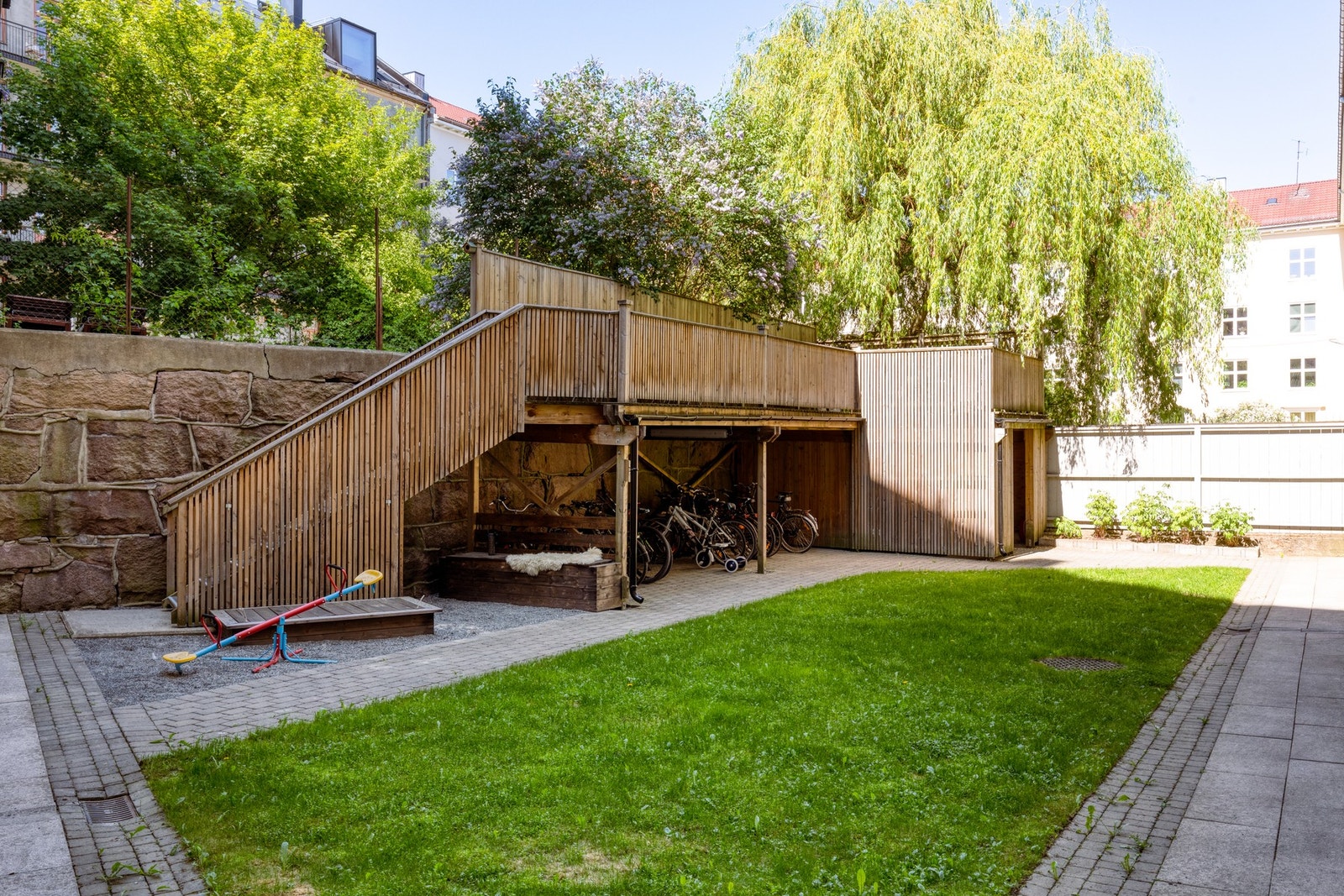 Bakgården ble i 2014 totalrenovert med nytt steindekke, gressplen, ny drenering og et bygg med sykkelskur under Galleribilde