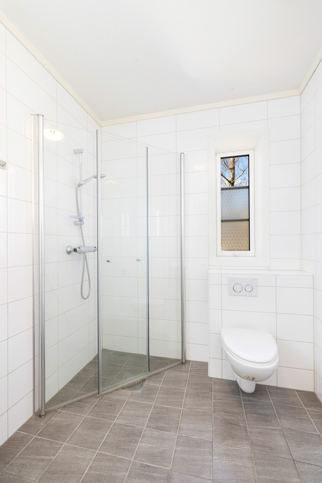 Badet er flislagt og har behagelige varmekabler i gulv Galleribilde
