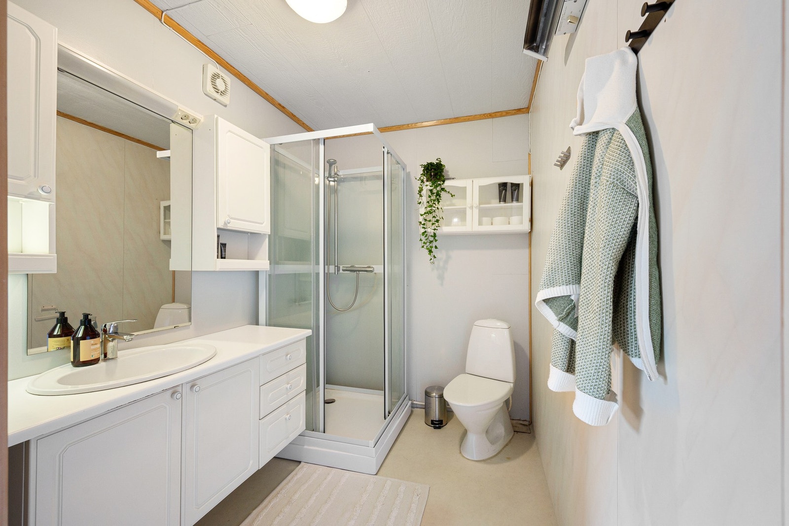 Badet inneholder baderomsinnredning, dusjkabinett og toalett Galleribilde