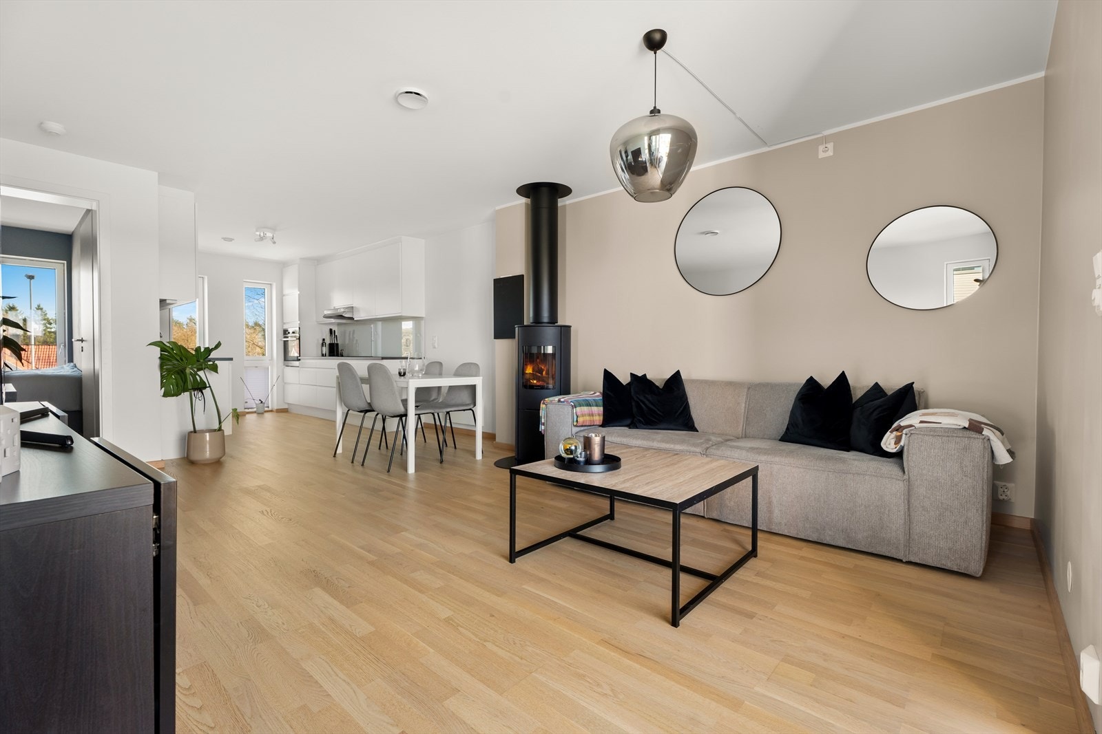 Stuen har god plass til både sofagruppe og spisebord, og vedovnen blir et naturlig samlingspunkt. Galleribilde