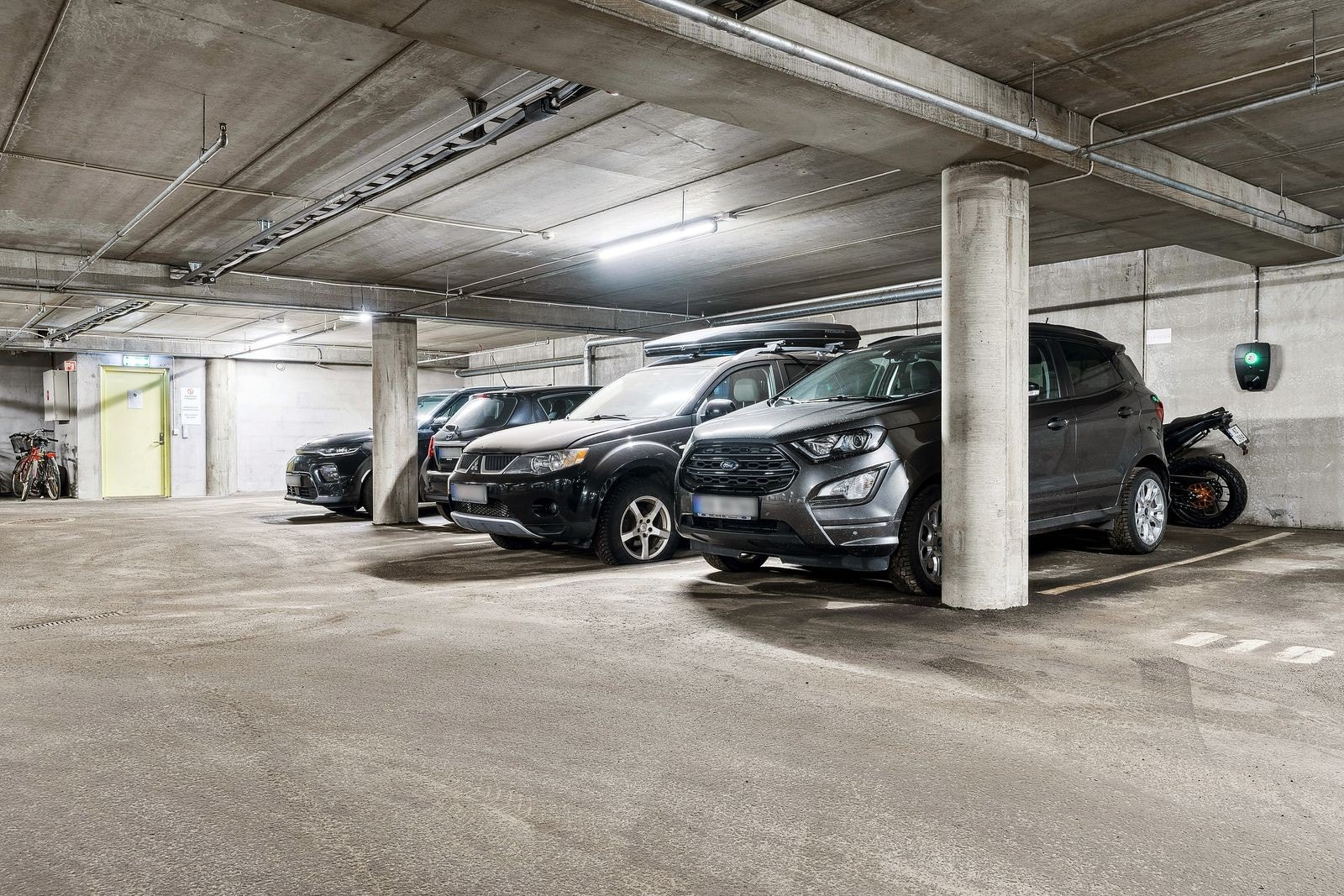 Fast parkeringsplass i garasjen med elbil-lader Galleribilde