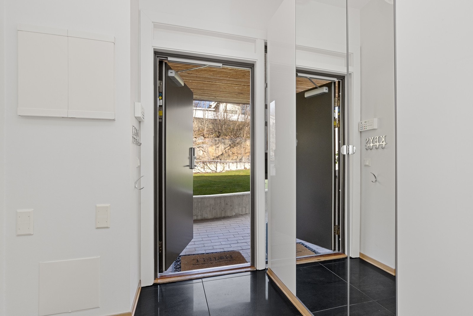 Velkommen inn! Entréen har garderobeskap for praktisk oppbevaring og kodelås fra Yale Doorman, installert i 2018. Galleribilde
