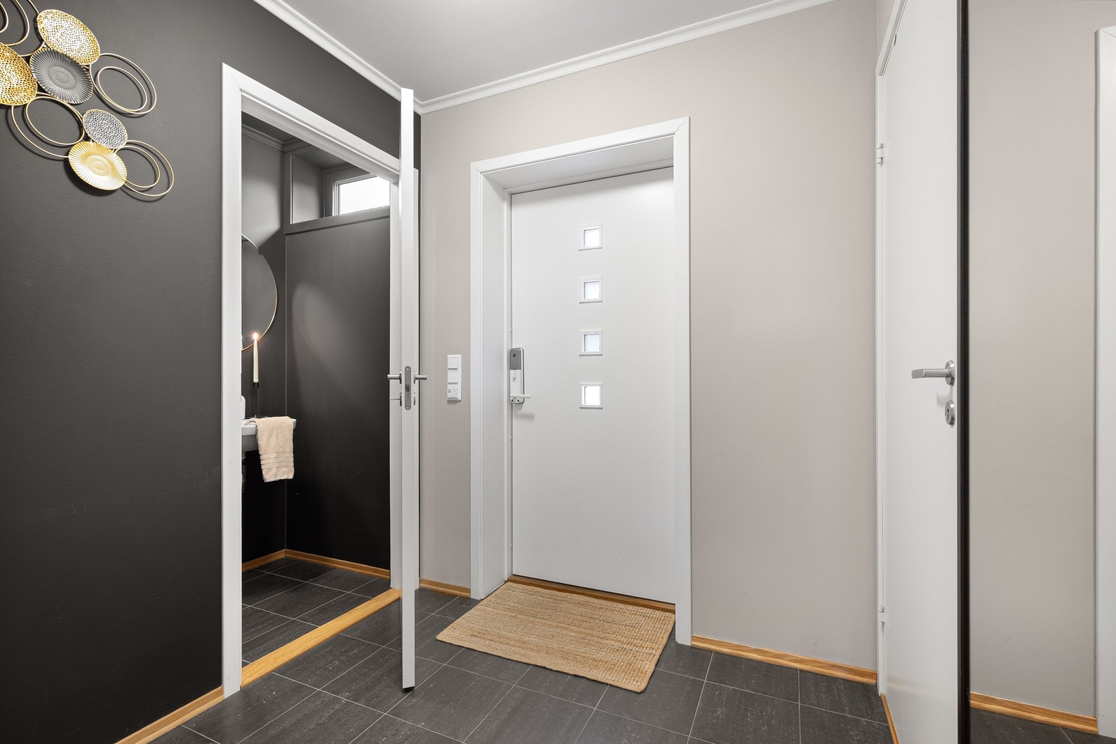 Romslig entré med god plass til å henge fra seg yttertøy og skotøy. Her har man også inngang til teknisk rom/bod for ekstra oppbevaring. Galleribilde
