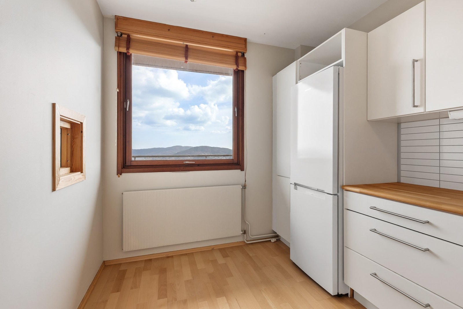 Innredningen har frittstående komfyr og kjøleskap samt oppvaskmaskin og kjøkkenventilator med avtrekk til innvendig rom Galleribilde