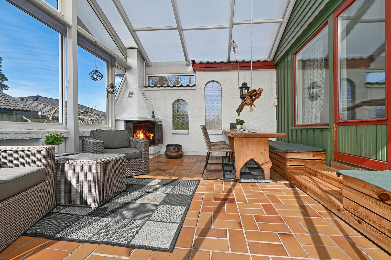 Innglasset uteplass med peis og store vinduer som slipper inn mye naturlig lys. Galleribilde