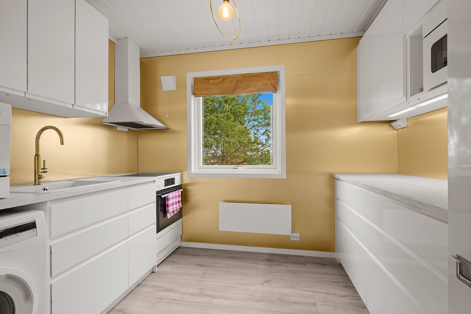 Kjøkkenet har en pen, slett innredning fra IKEA (2021). Galleribilde