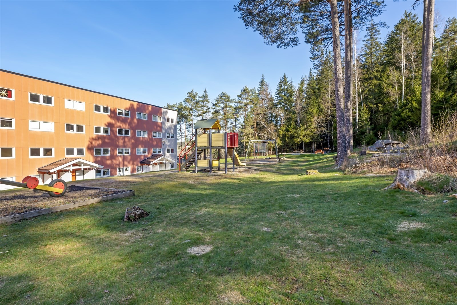 Felles tomt opparbeidet med gressplen, busker og sittegrupper Galleribilde