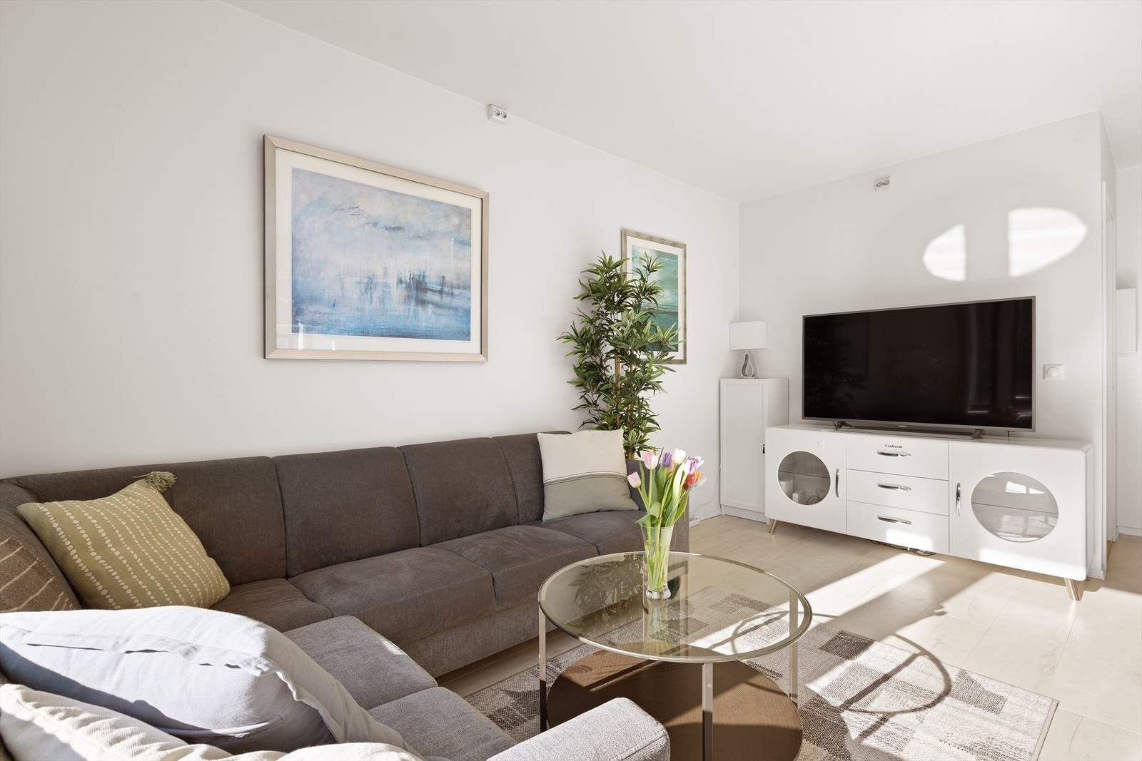 Stuen har god plass til en romslig sofagruppe og er et naturlig samlingspunkt i boligen. Galleribilde