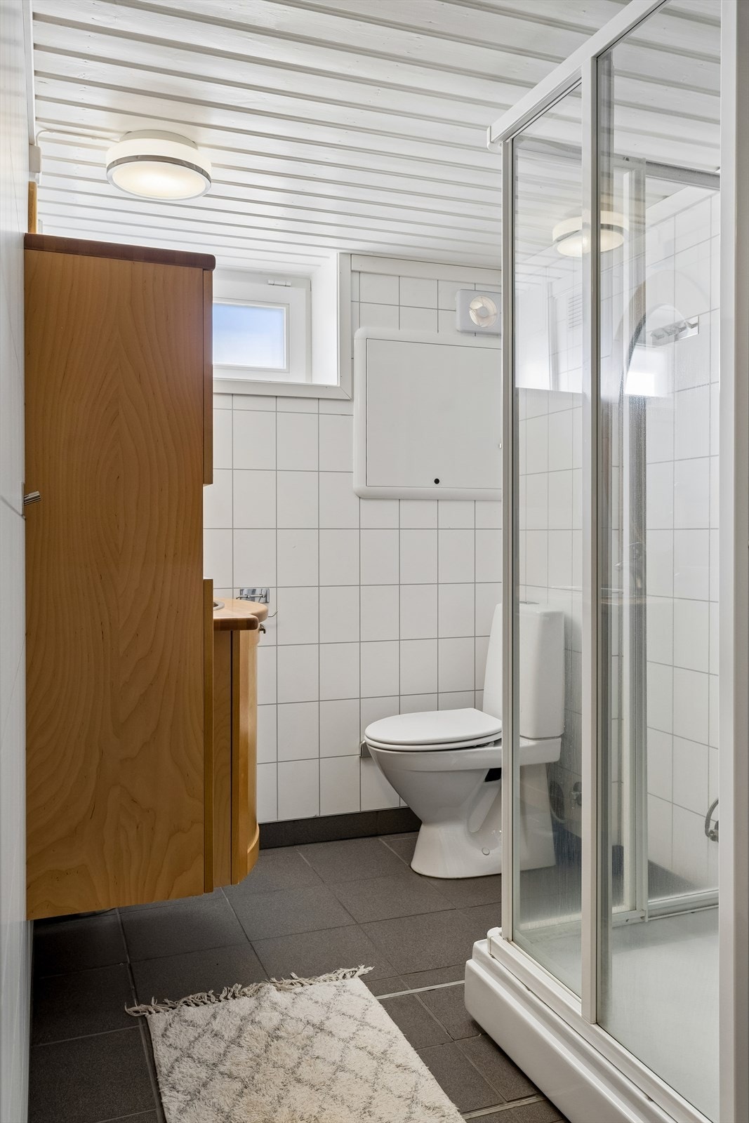 Funksjonelt bad i kjelleretasjen fra 2012, utstyrt med dusjkabinett og gulvvarme. Galleribilde