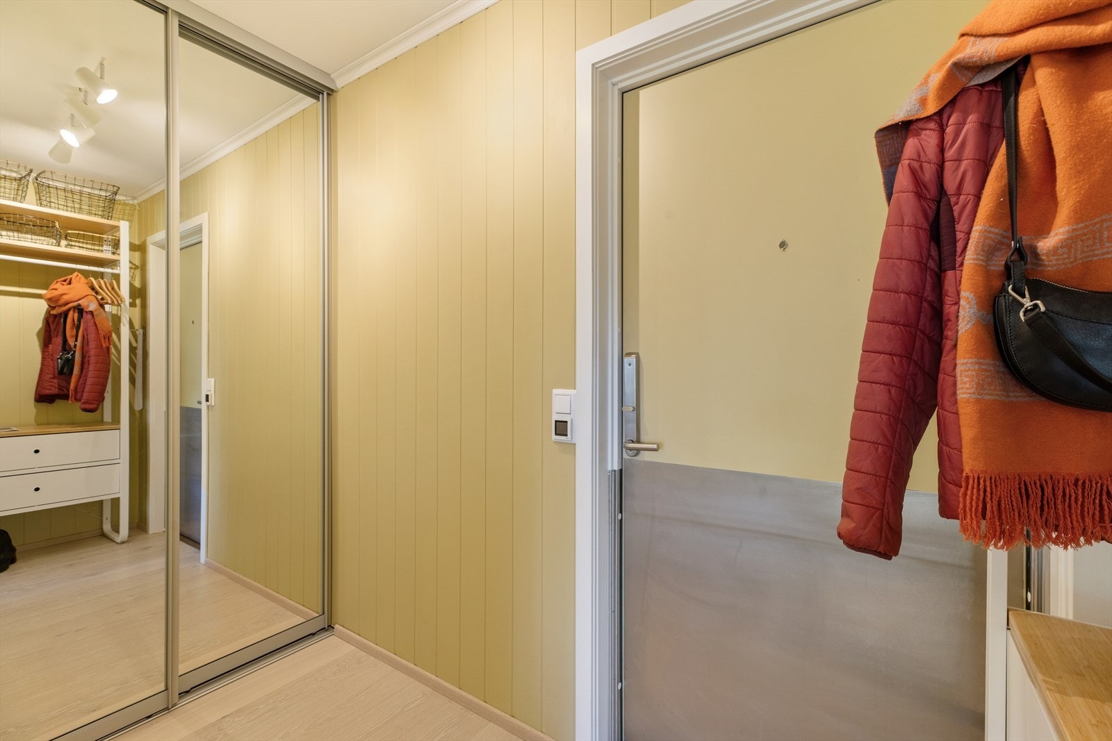 Romslig og hyggelig entré med god oppbevaringsplass i skyvedørsgarderobe med speilfronter og installert lys. Galleribilde