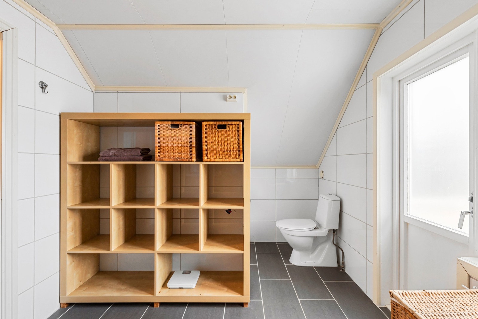 Badet er utstyrt med dusjkabinett, wc, servant og servantskap. Gulvvarme. Galleribilde