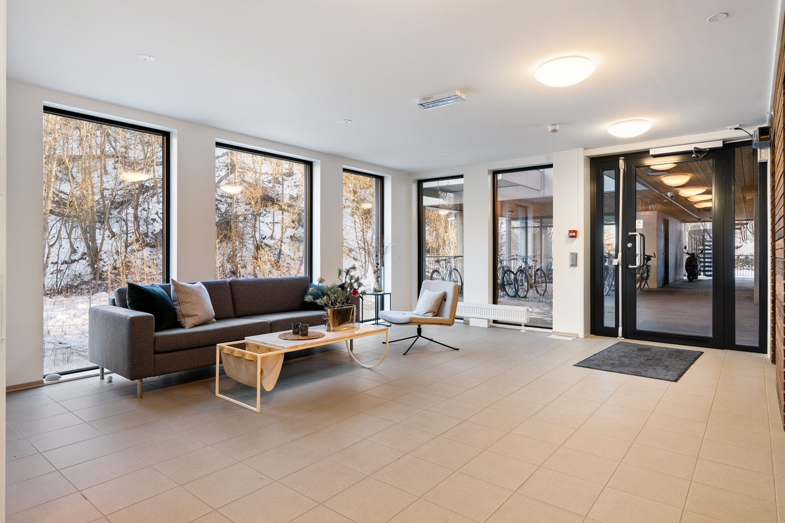 Hyggelig inngangsparti til bygningen med sittegruppe og sykkelparkering rett utenfor. Galleribilde