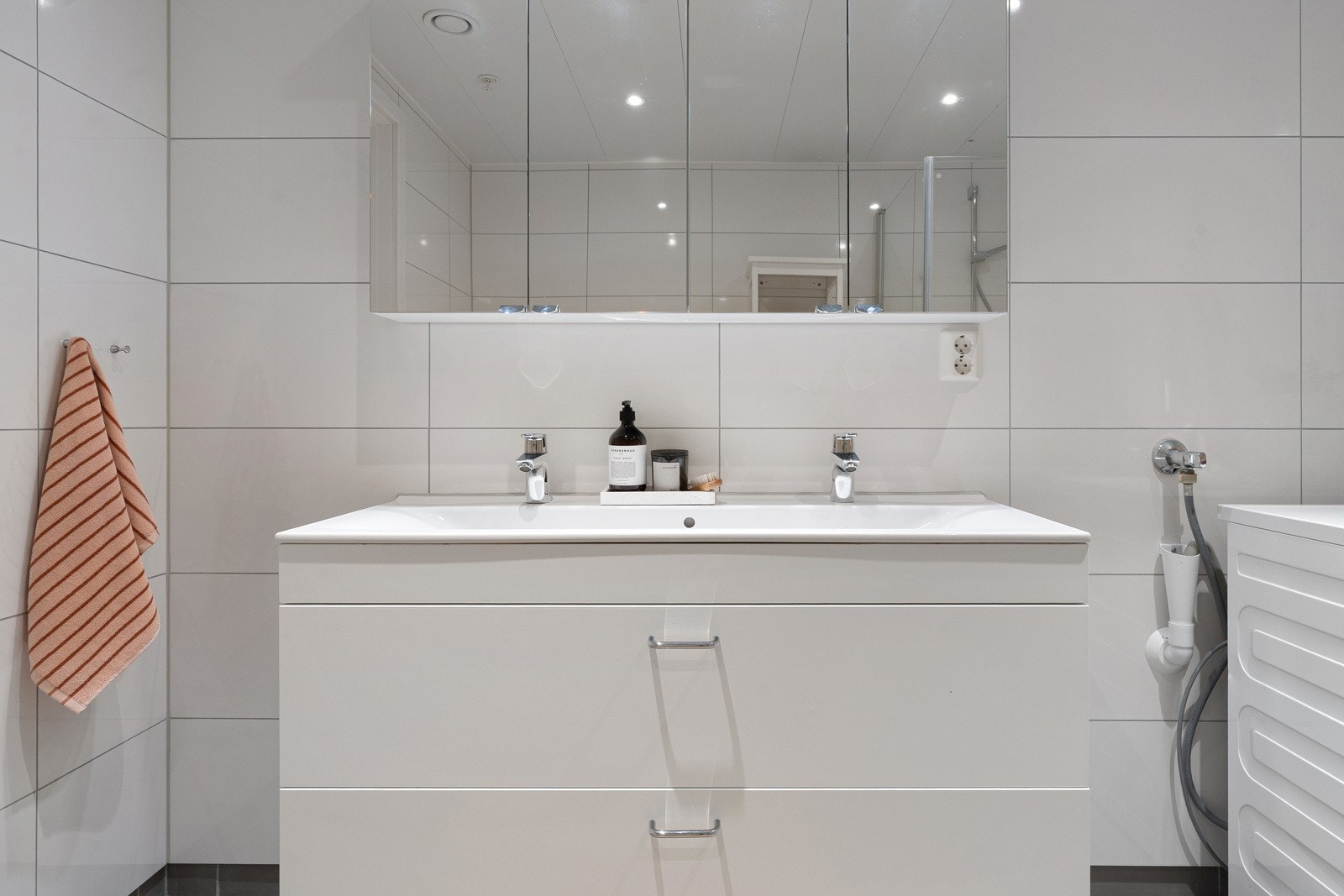 Lys baderomsinnredning med heldekkende dobbel servant og speilskap