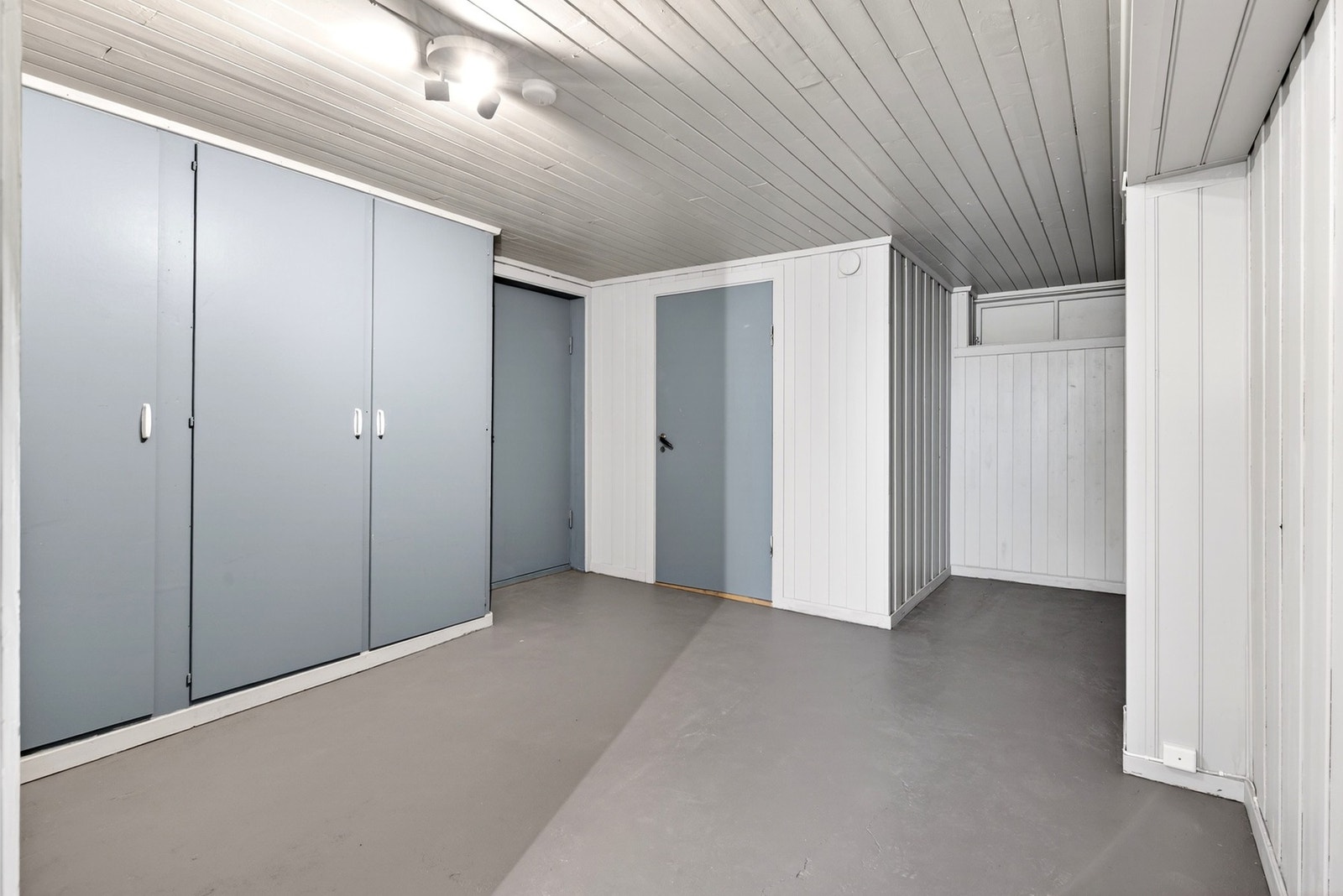 Innbydende kjellergang med garderobeskap, tilgang til oppholdsrom og bod, og rom for møblering. Galleribilde
