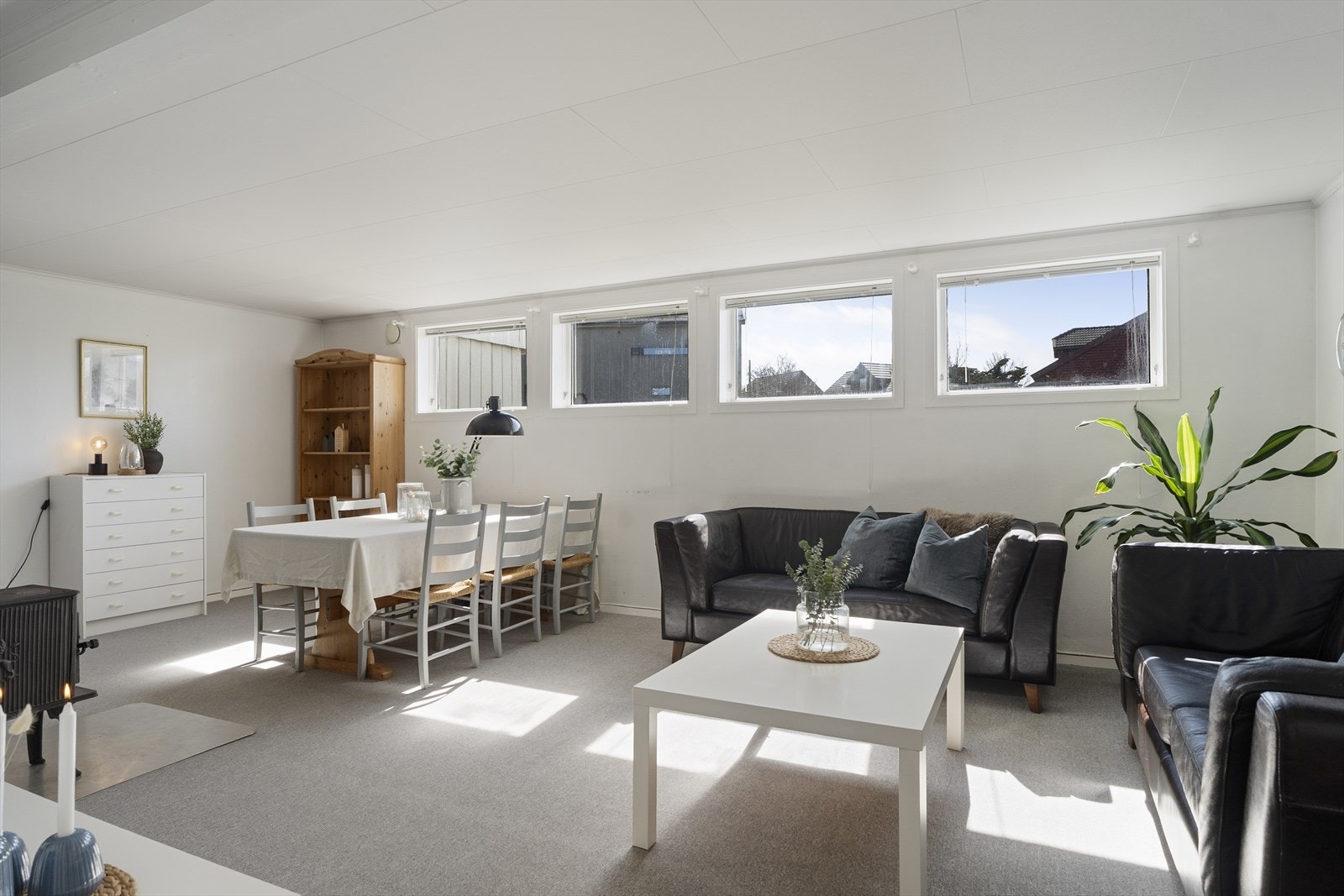 Leiligheten har en lys og pen stue med plass til både sofagruppe og spisebord Galleribilde