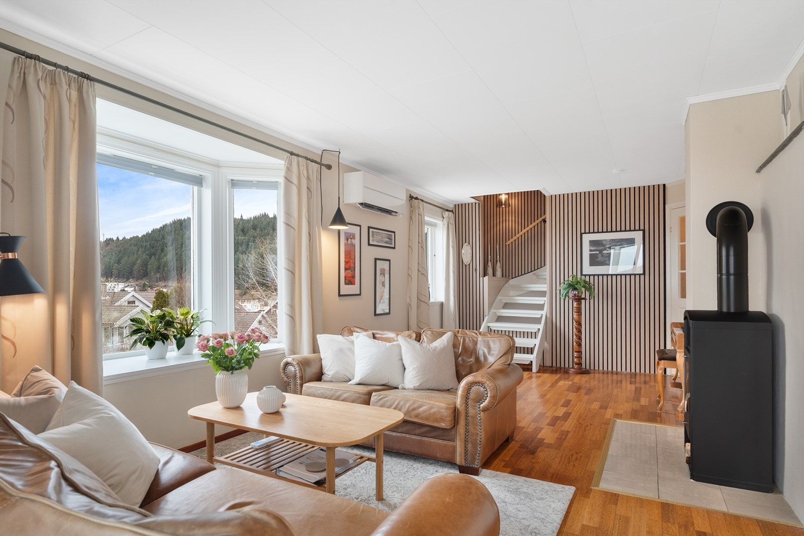 Boligen har en lys og flott stue med moderne spilevegg Galleribilde