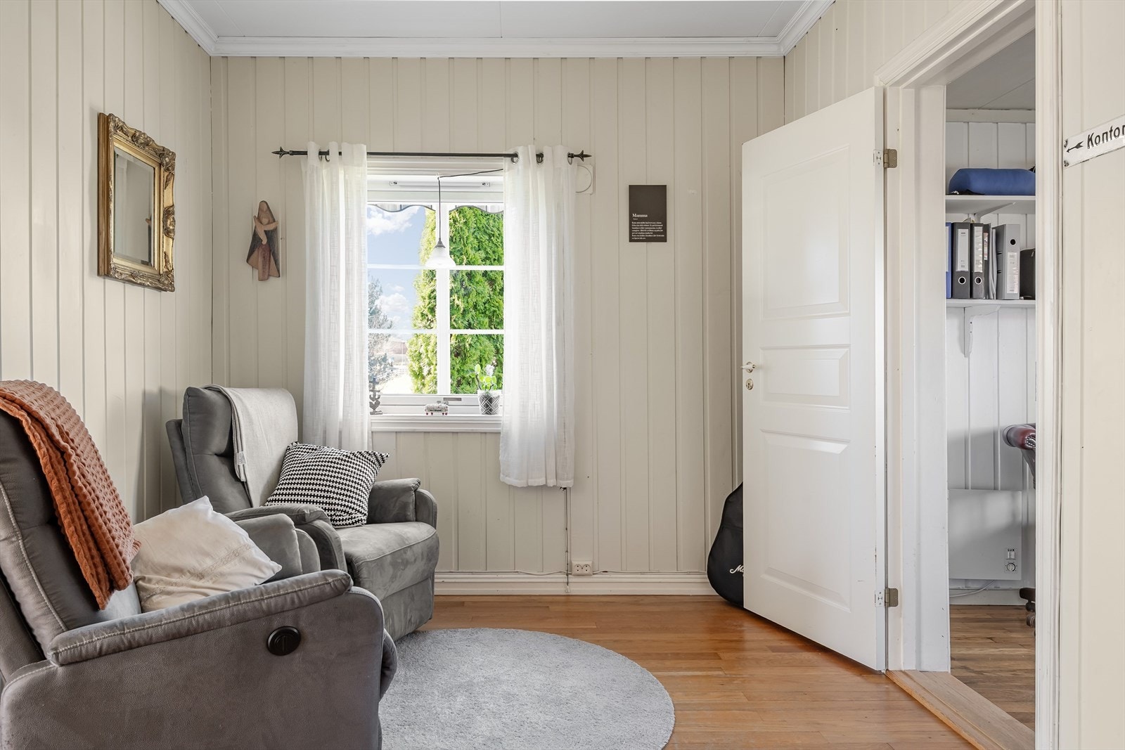 Rommet har malt panel på veggene og gulv av lakkert heltre. Galleribilde