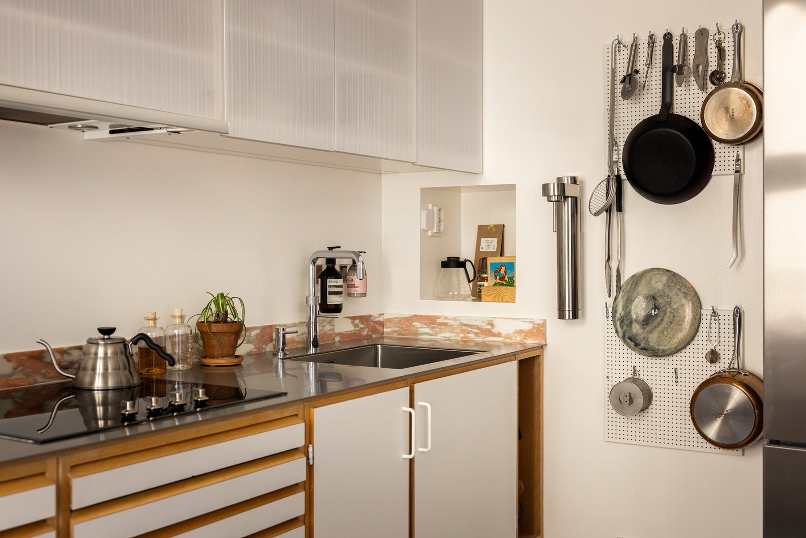 Både stilrent og praktisk ned benkeplate av rustfritt stål med underlimt oppvaskkum. Legg også merke til den innebygde hyllen som er perfekt for kaffemaskin! Galleribilde