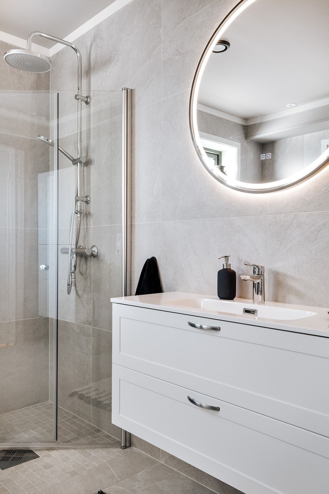 Badet er utstyrt med en pen baderomsinnredning med skuffer og heldekkende servant med ett-greps blandebatteri. Galleribilde