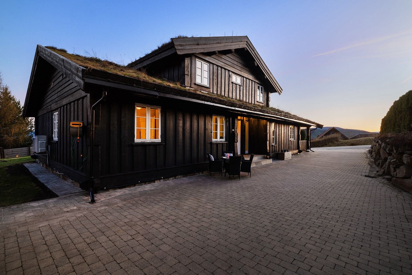 Eiendommen er pent opparbeidet med belegningsstein på en romslig gårdsplass. Galleribilde