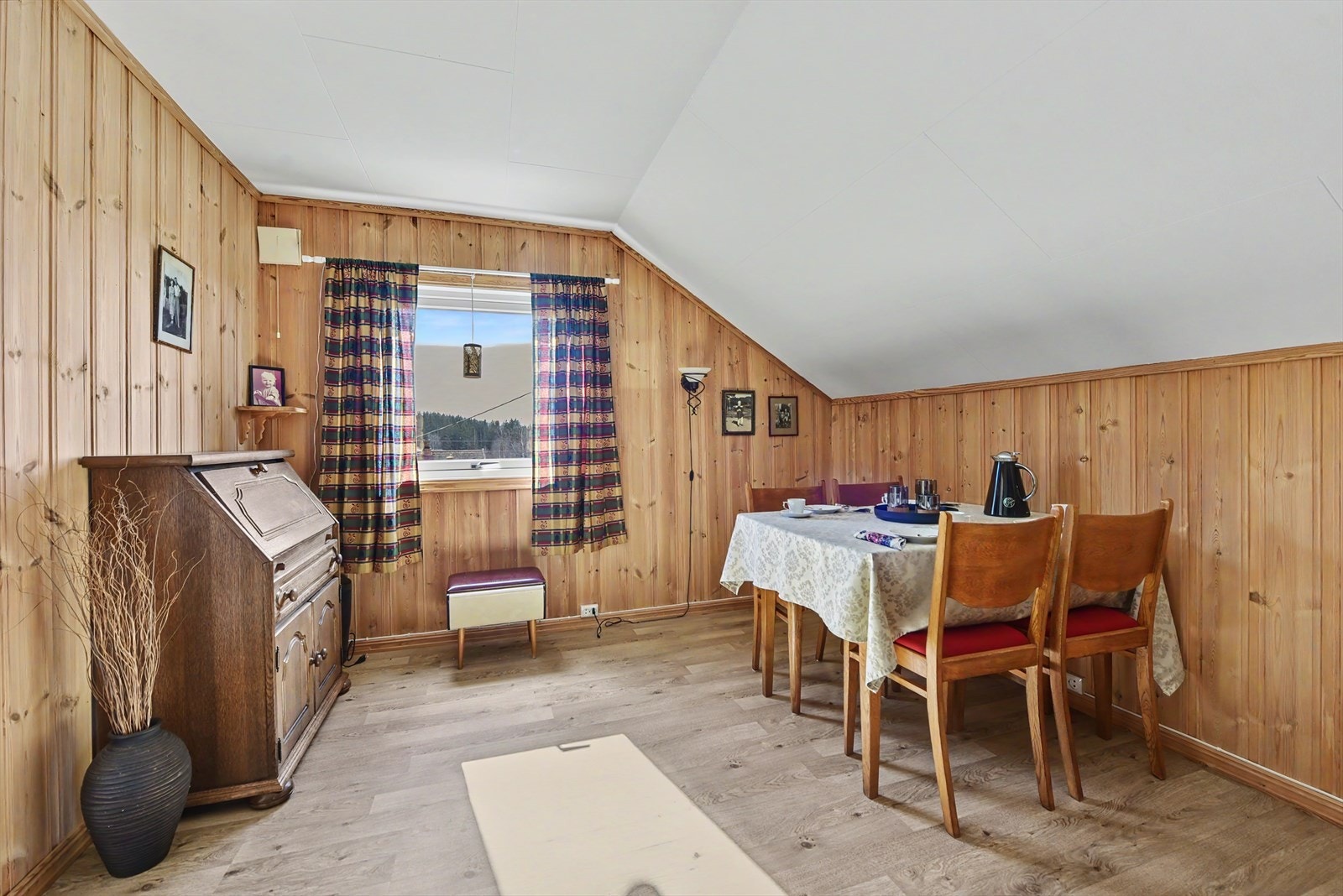 Stuen i andre etasje har vegger med trepanel som gir en lun atmosfære. Galleribilde