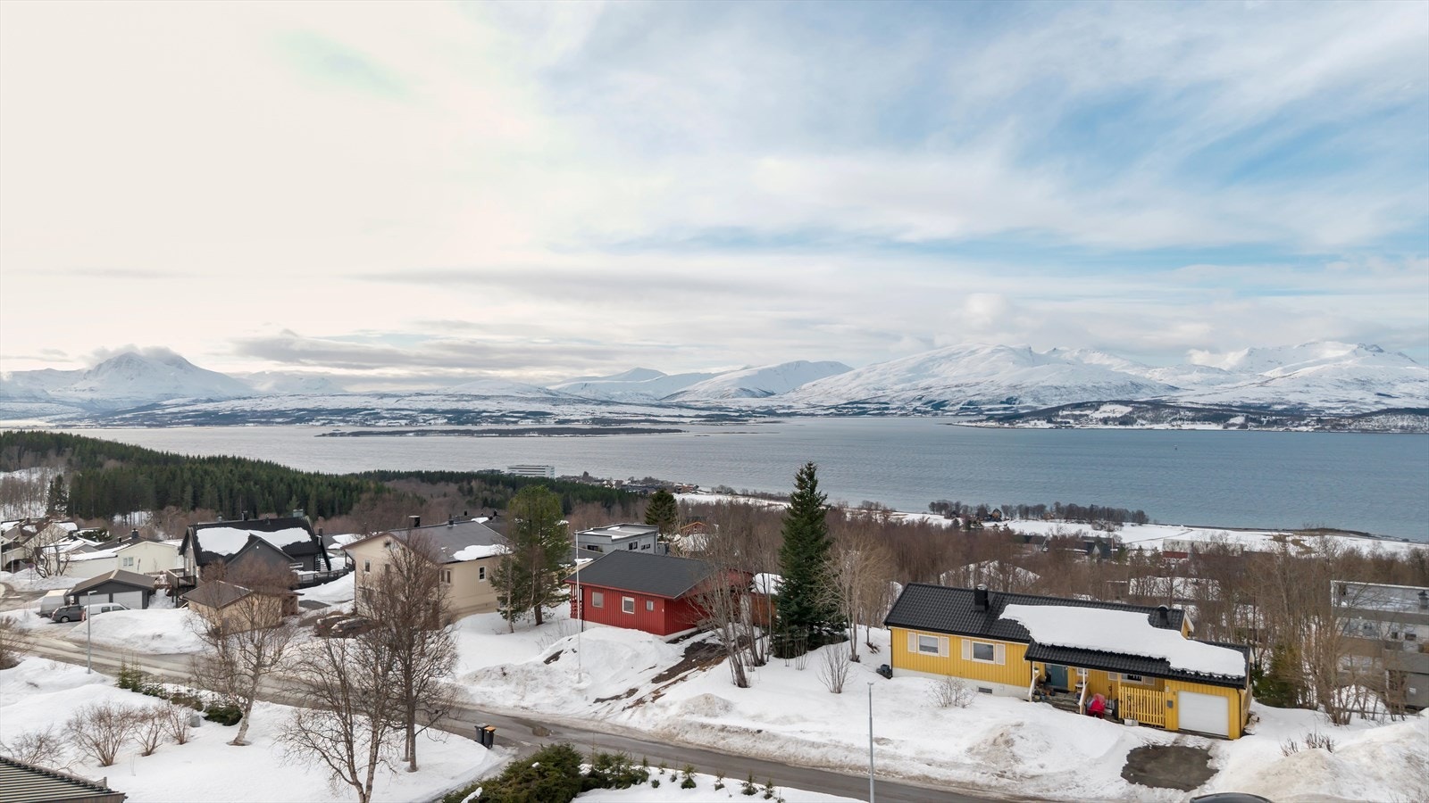 Vestvendt stue, veranda og uteplass mot friområde - utsikt mot Sandnessundet og Kvaløya. Galleribilde