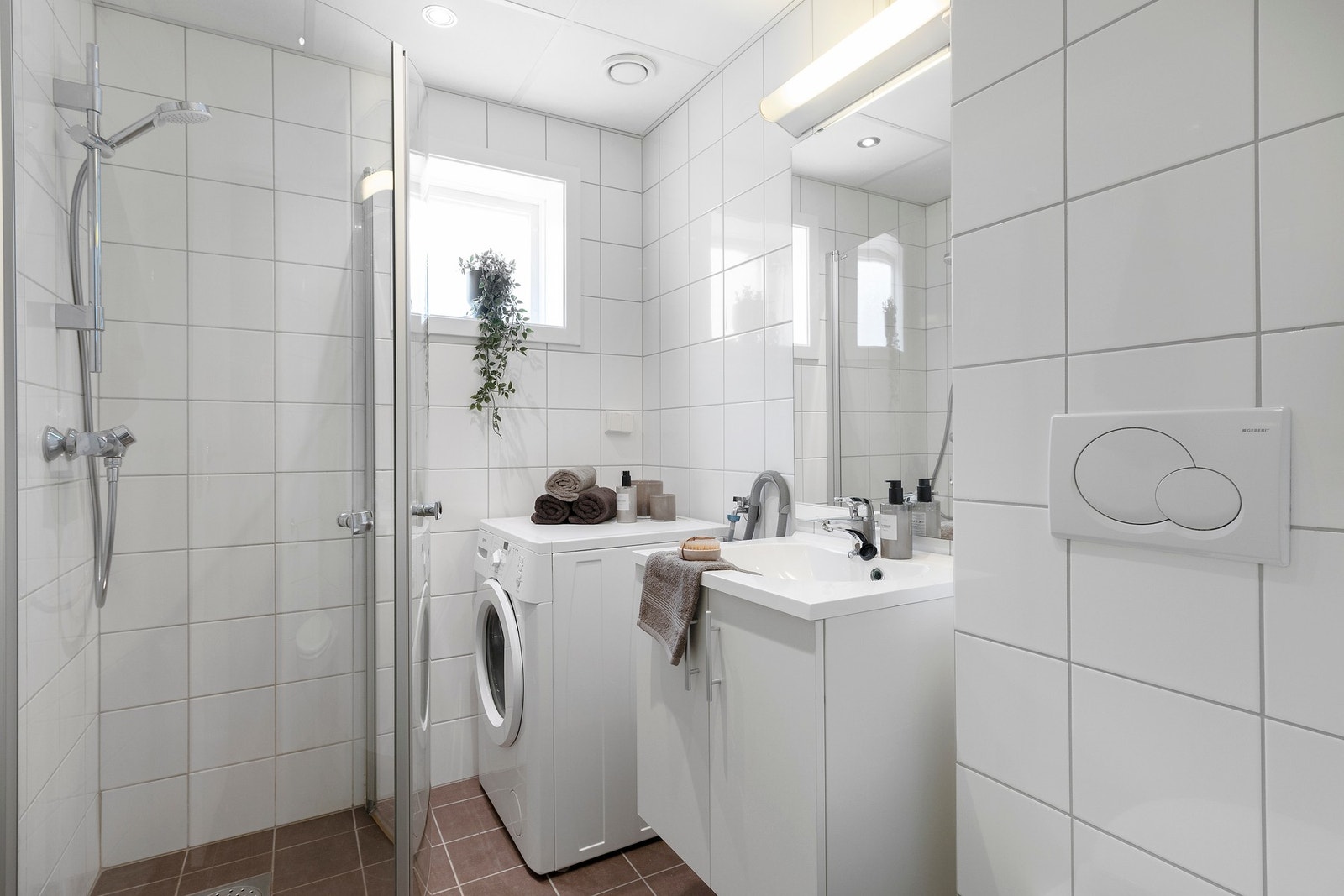 Flislagt bad med opplegg til vaskemaskin. Galleribilde