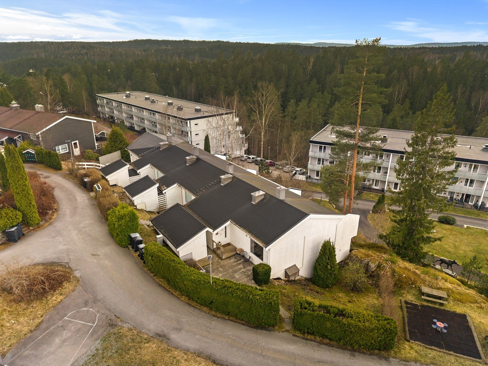 Boligen ligger plassert på skrånende tomt i et barnevennlig område, nær marka og grønne skogsområder. Galleribilde