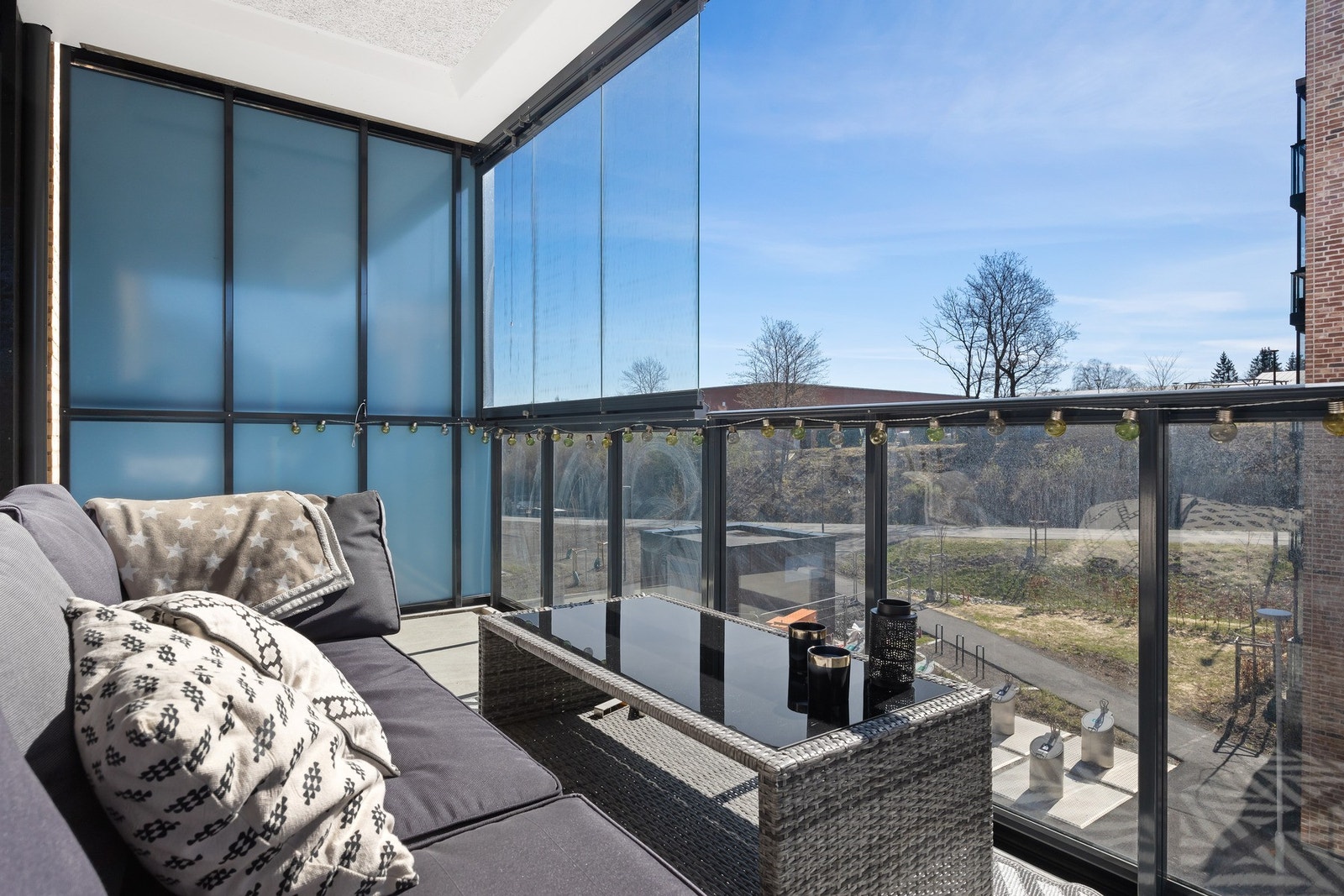 Innglasset balkong med utsikt mot grøntområde. Galleribilde