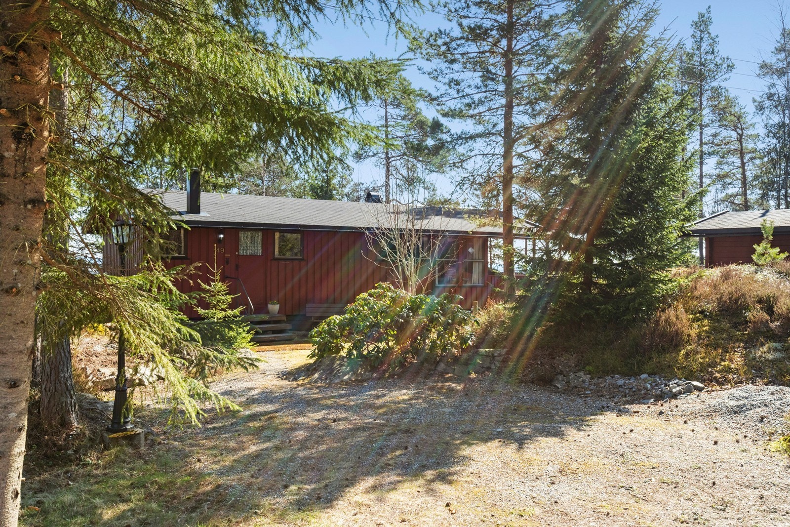 Naturtomten er opparbeidet med plenareal, trær og beplantning som glir naturlig inn i omgivelsene. Galleribilde