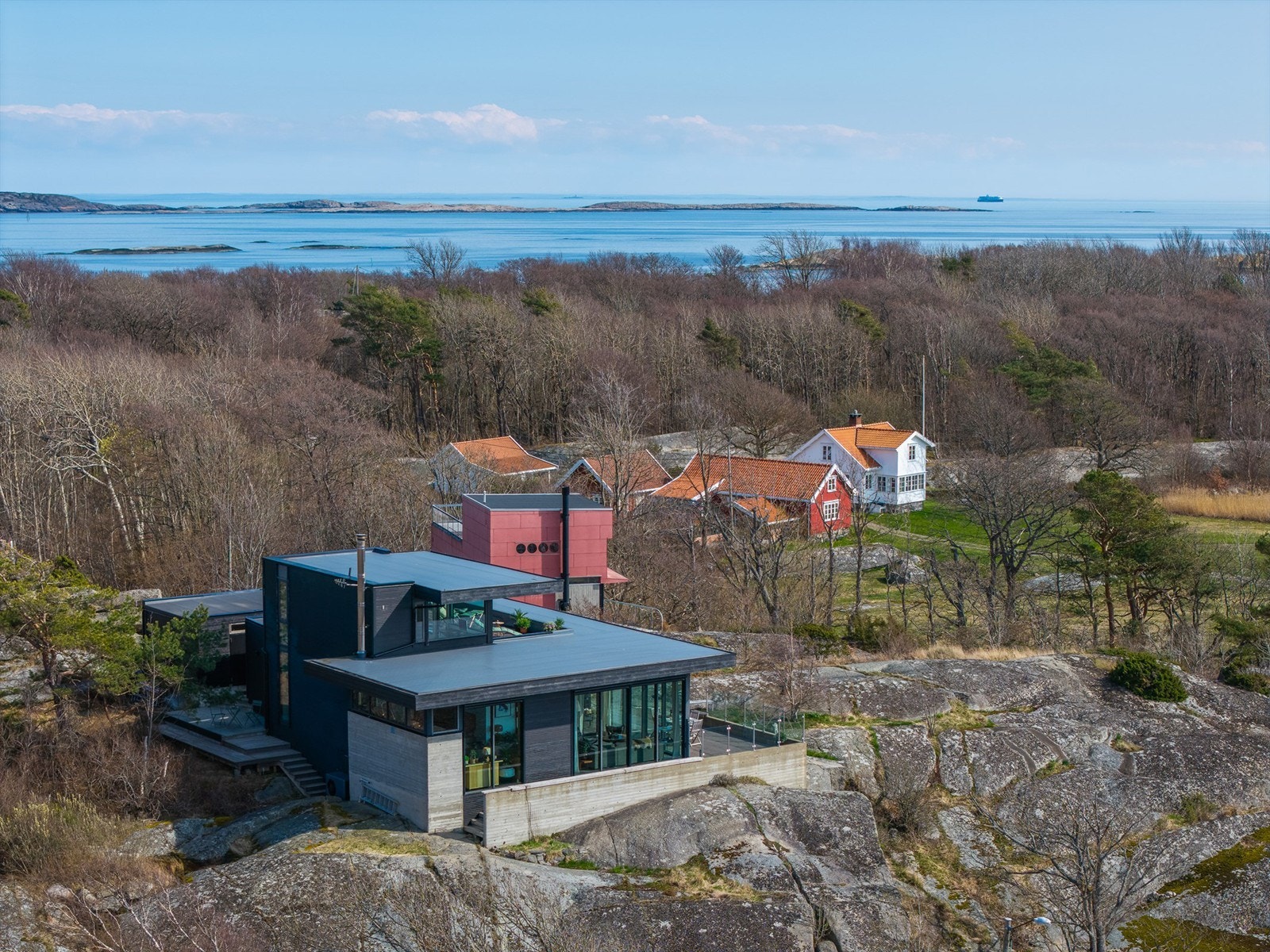 Boligen er fundamentert direkte på fjellet, og kombinasjonen av betong, tre og store glassflater skaper en unik dialog med den omkringliggende naturen og havet. Galleribilde