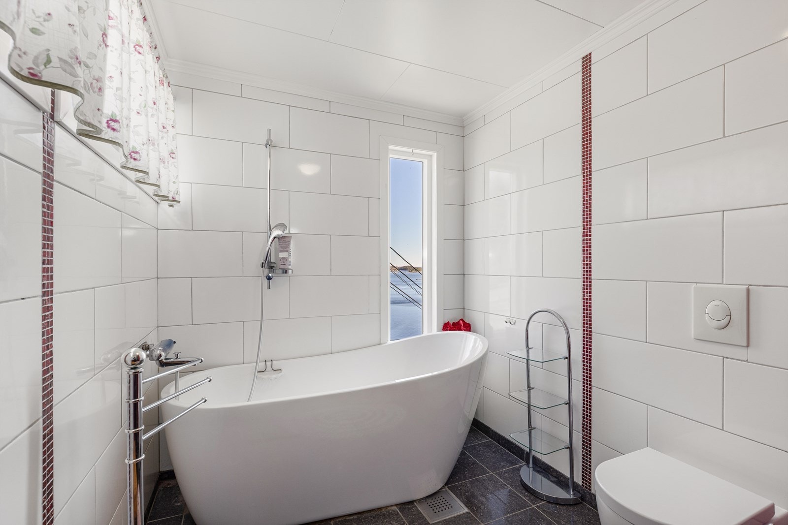 Badet på hovedplanet har flislagt gulv med varmekabler, fliser på vegg og malte himlingsplater. Galleribilde
