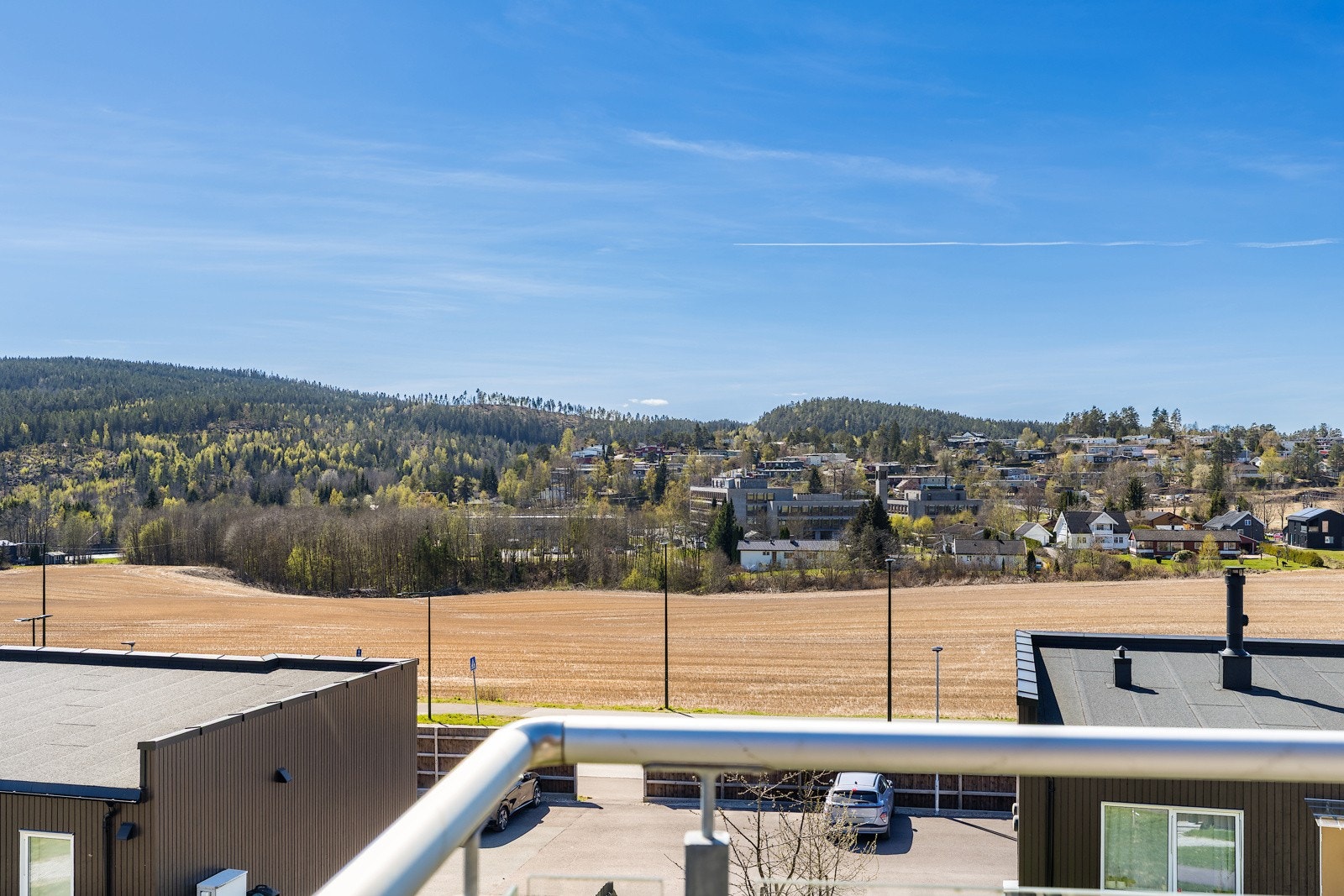 Utsikten fra takterrassen strekker seg over kulturlandskap og skogkledde åser. Galleribilde